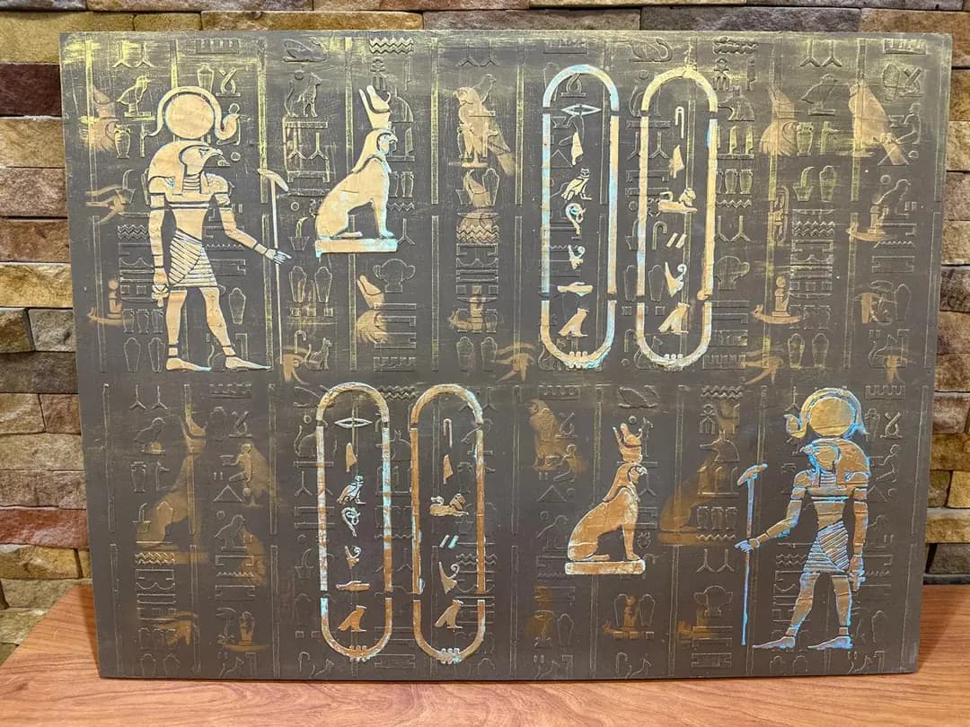 A hand-carved panel of gilded hieroglyphs